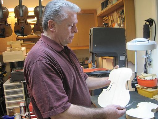 Marcel, Business Owner working on a Violin in The Workshop